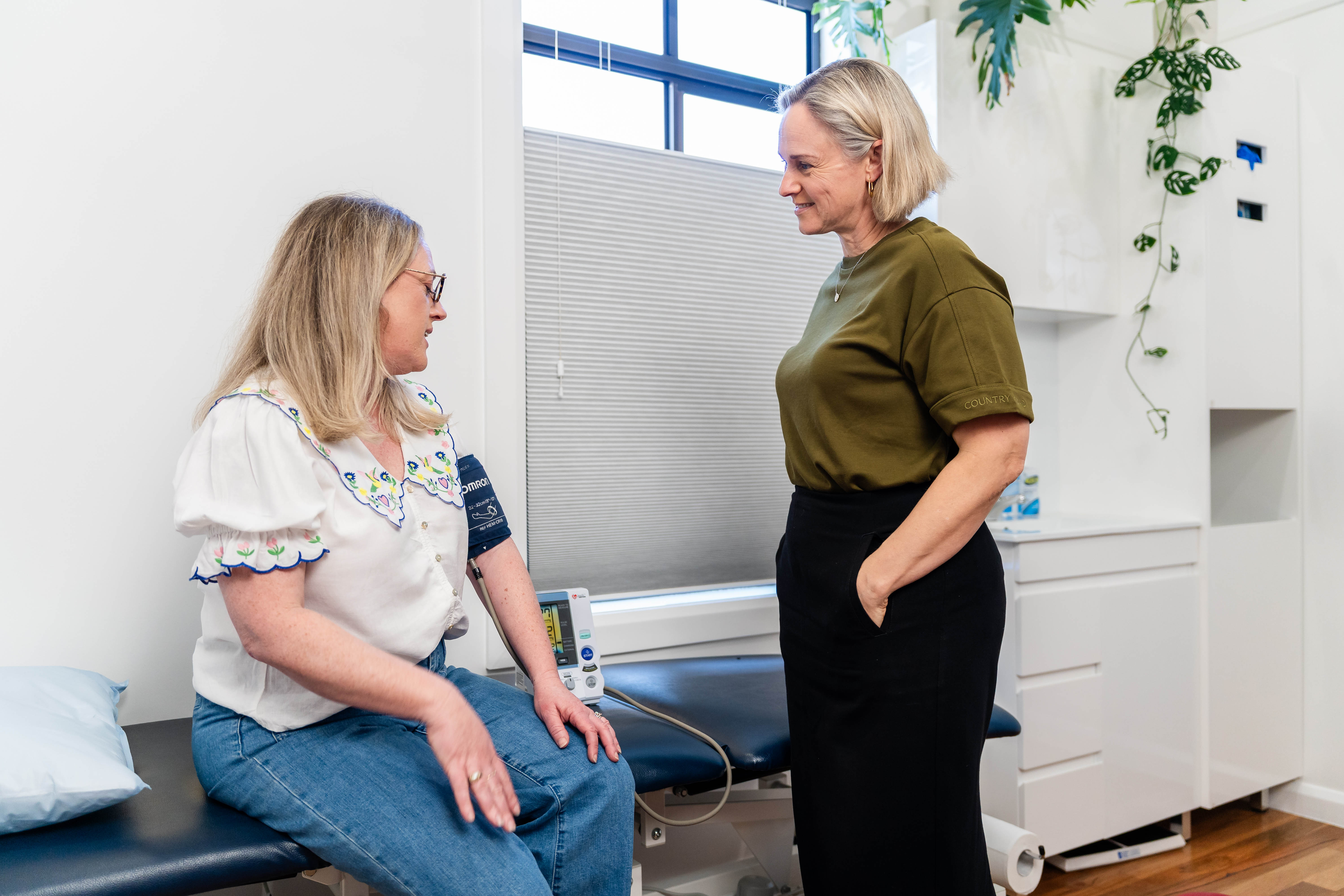 Dr Kimberley Elliott checking a woman's blood pressure